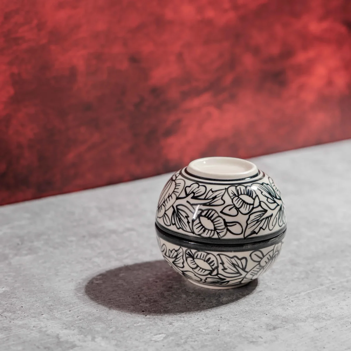 Monarca Ceramic Katori Bowls – Set of 2 by Harmiche. Hand-painted black floral design, microwave & dishwasher safe. Perfect for curries, dal & desserts.