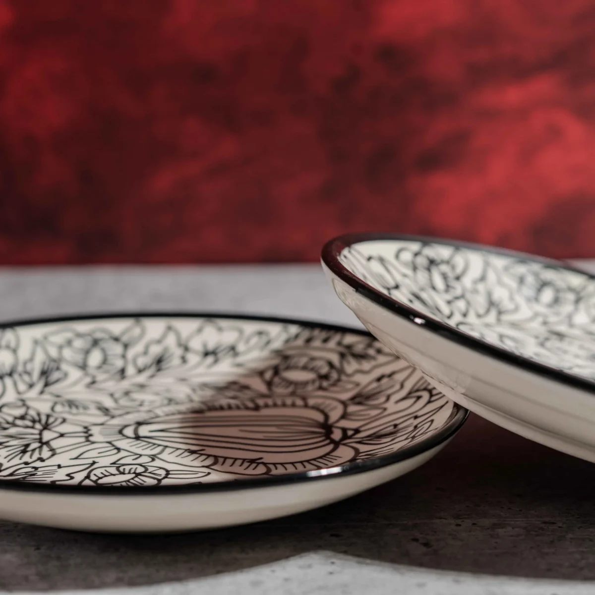 Monarca Ceramic Quarter Plates – Set of 2 (7 inches) by Harmiche. Hand-painted black floral design, microwave & dishwasher safe. Perfect for sides & desserts.